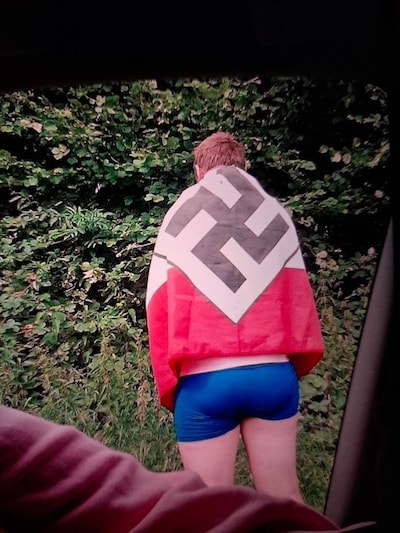 ‘Dit was een grote fout’: Belgische politicus door het stof om foto in onderbroek met nazivlag